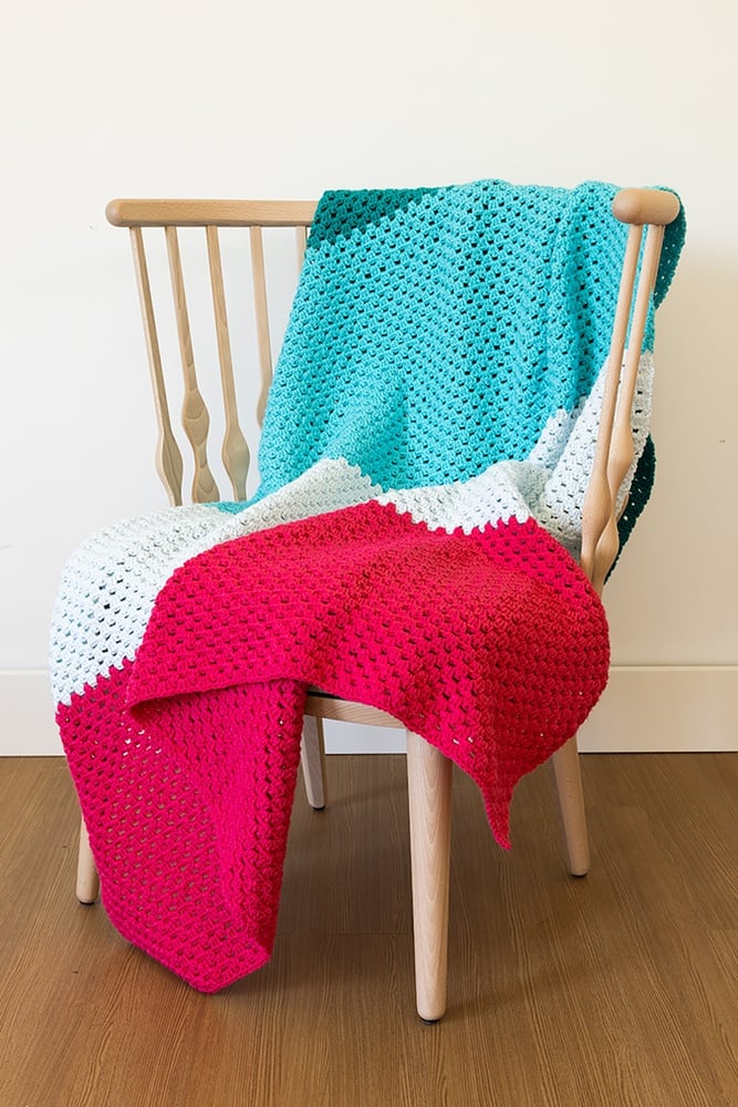 Designed by Heidi Wells and available as a free pattern download from KnitPicks, the Crochet Beginner Blanket was made with Worsted Weight Yarn and a 6 mm (J) crochet hook. When complete the 4 color blanket measures 50 inches X 60 inches in size. Watch the video tutorial on YouTube. Get the free pattern by tapping the button below! Have fun!