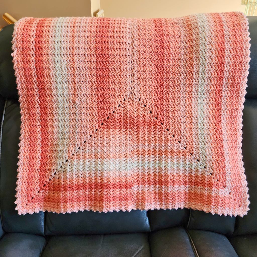 Designed by Rhondda at Oombawka Design Crochet, the Endless Rectangle Blanket Pattern is available in 7 popular sizes. It was crocheted with Ombre Medium Weight Yarn and a 6.5 mm (K) crochet hook. Get the free pattern on my site and watch the video tutorial here on YouTube.
