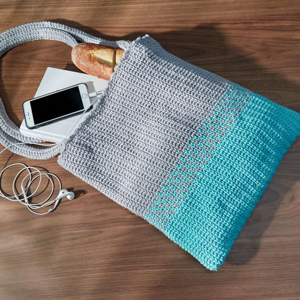 This Easy Split Tote is beautiful and you can learn how to crochet it by following along with this video prepared by Marly Bird. The crochet tote bag pattern is available as a free PDF download from Yarnspirations.