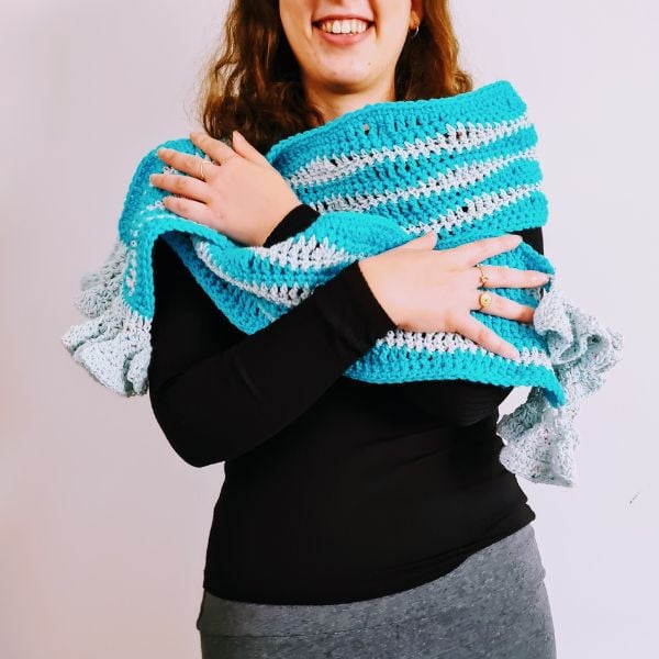 Crochet this pretty ruffled scarf with your favorite DK Weight / Light Weight yarn and a 5 mm (H) crochet hook. The pattern is available for free from Sandra Stitches.