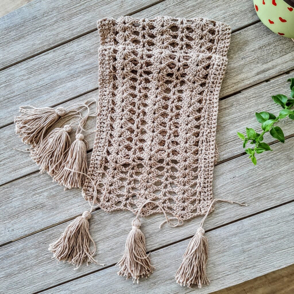 Bring a cozy, bohemian vibe to your dining table with this free crochet table runner pattern. Featuring a beautiful shell stitch and customizable size, this pattern is perfect for adding unique style to your home.