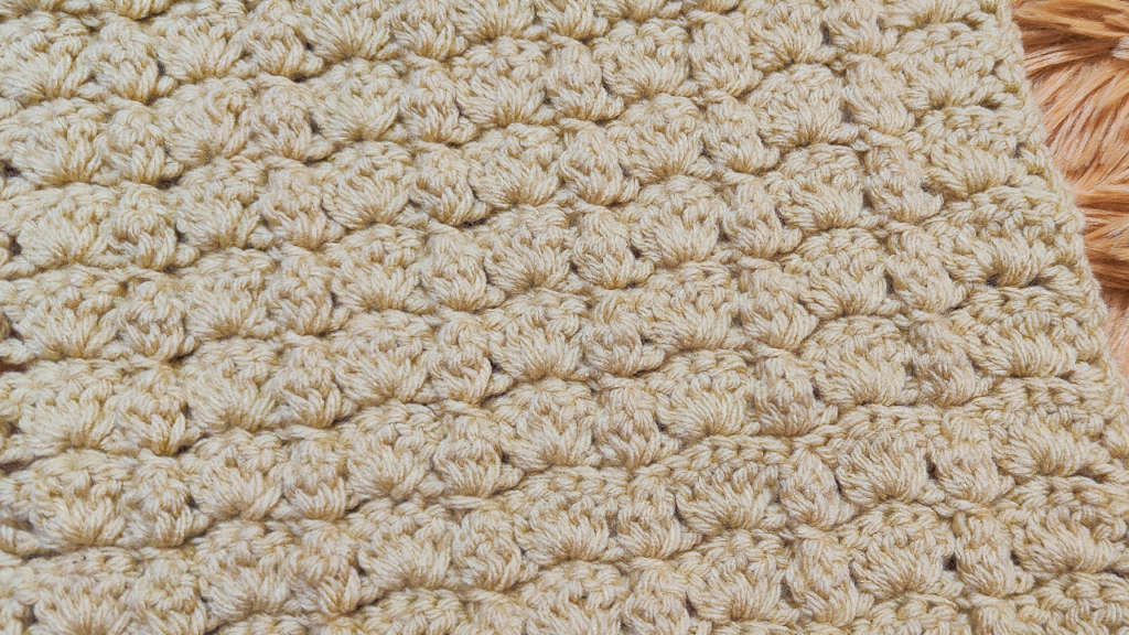 Craft a cozy blanket with this free Shells and Clusters Crochet Pattern. Features shell stitches, double crochet clusters, and front post single crochets. #crochetblanket #freecrochetpattern #easycrochet #shellstitch #clusterstitch