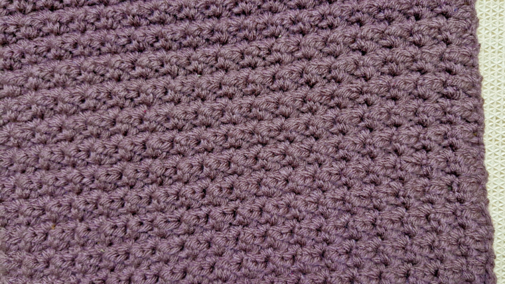 Crochet a soft, textured blanket using simple stitches! This one-row repeat design works up beautifully in any size.