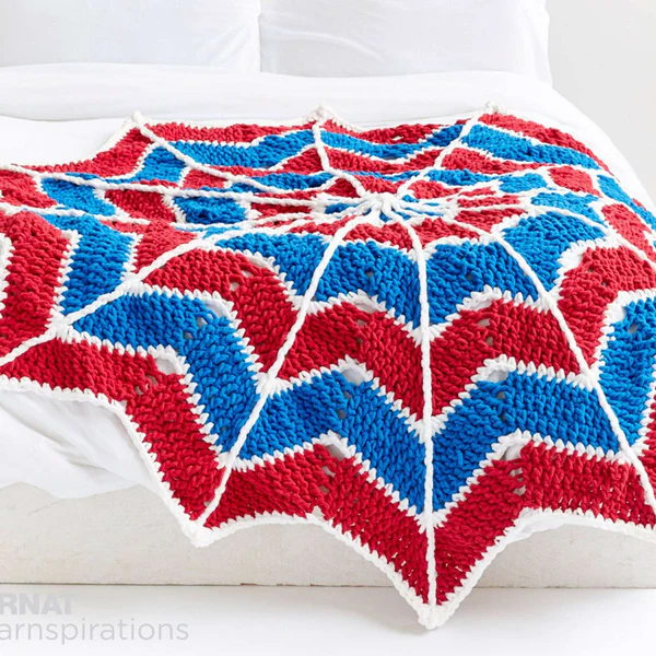 Made in bright red, blue and white blanket yarn with a 9 mm crochet hook, this blanket works up quickly! Mikey from the Crochet Crowd has filmed a helpful step-by-step video to make it too! Get the free PDF pattern from Yarnspirations.