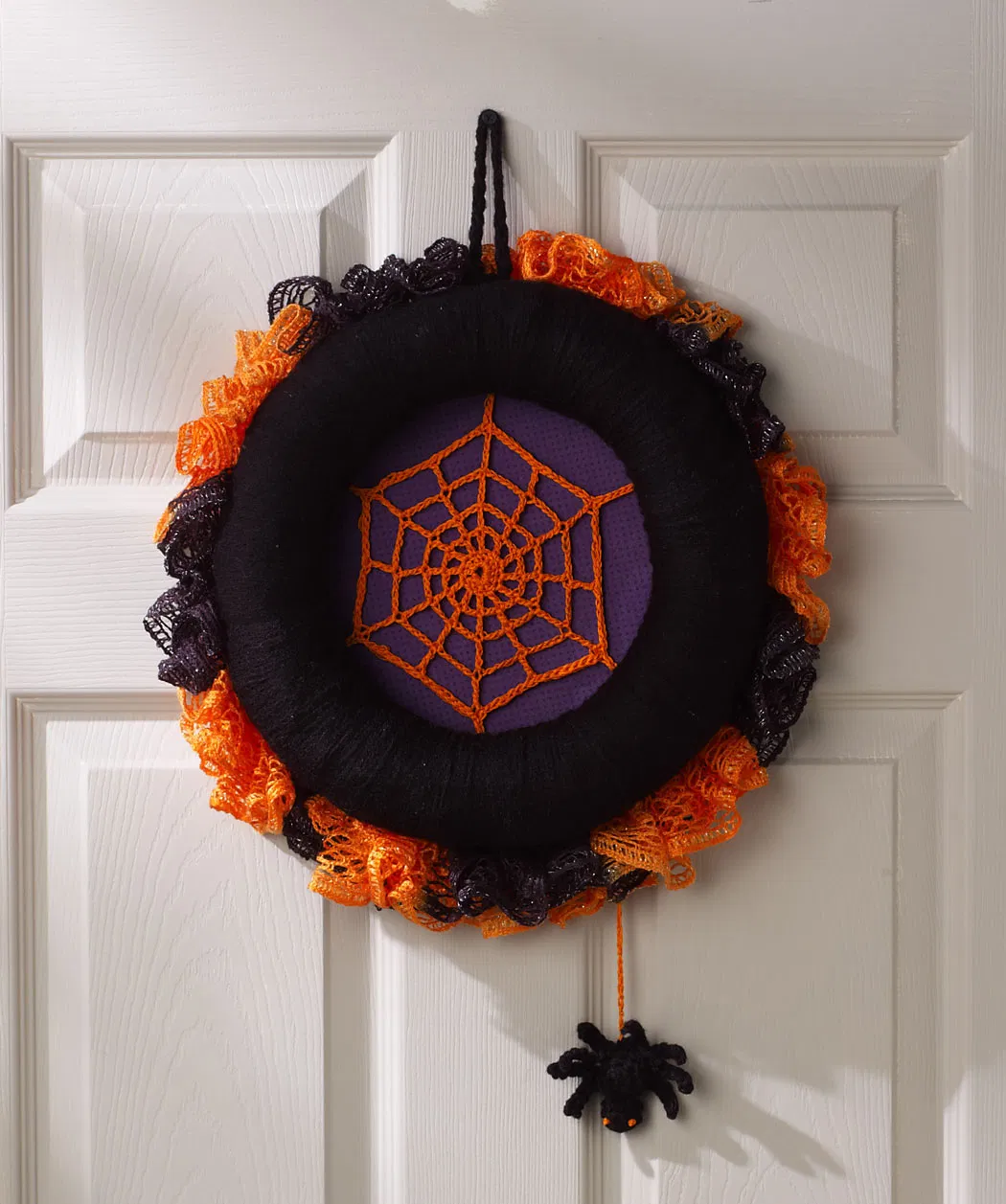Designed by Michele Wilcox and crocheted with Aran Weight [4] Yarn, this unique Spiderweb Halloween Wreath pattern is available as a free PDF from Ravelry. The instructions include a spiderweb and spider.