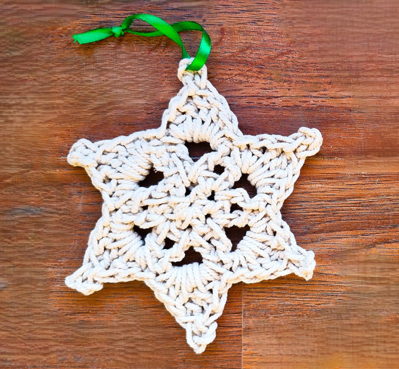 Crochet a textured snowflake ornament using macrame cord. This free tutorial includes written steps and a video. Perfect for quick holiday decorating and gift wrapping! Save it for later. #crochettutorial #freecrochettutorial #crochetpattern #crochetideas #crochetproject #crochetinspiration #freecrochetpattern