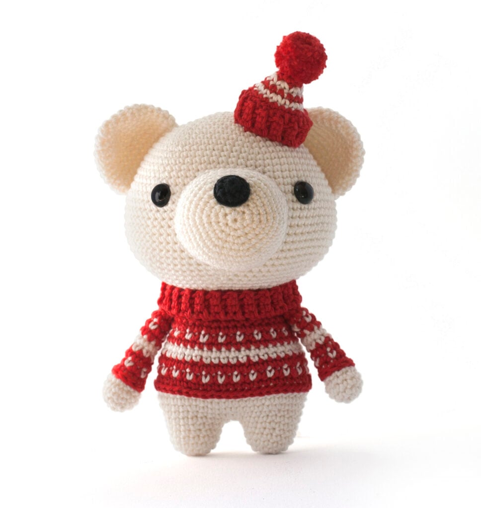 Make an adorable polar bear amigurumi with hat & scarf. Includes full video and step-by-step photos — ideal for beginners!